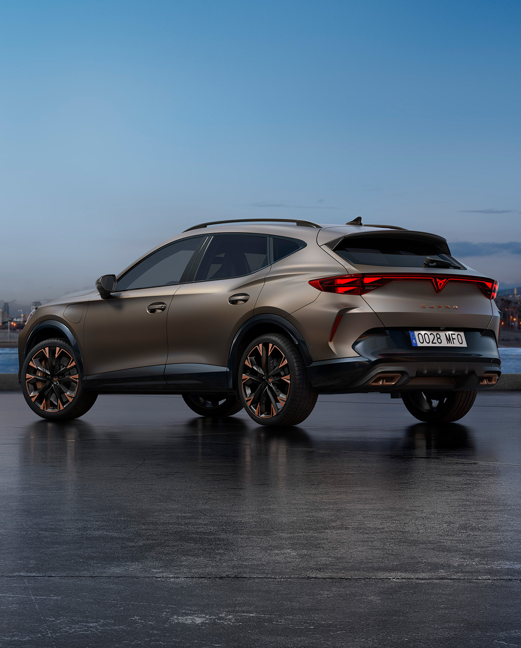 A new CUPRA Formentor 2024 century bronze matt CUV parked on a waterfront promenade during twilight. The background features a cityscape with skyscrapers and palm trees illuminated by the fading light of the day.