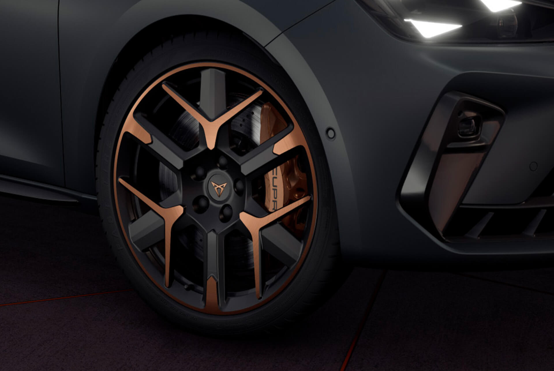 new cupra leon sportstourer 2024 close up of copper accent and black wheel and triangle eye cupra headlight, enceladus grey matt car body